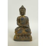 A Chinese bronze of Buddha seated in meditation, with a gilt patina, 9½" high