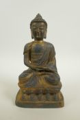 A Chinese bronze of Buddha seated in meditation, with a gilt patina, 9½" high