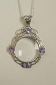 A 925 silver magnifying glass pendant necklace set with amethyst coloured stones, 2½" drop