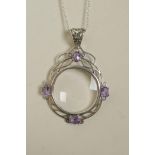 A 925 silver magnifying glass pendant necklace set with amethyst coloured stones, 2½" drop