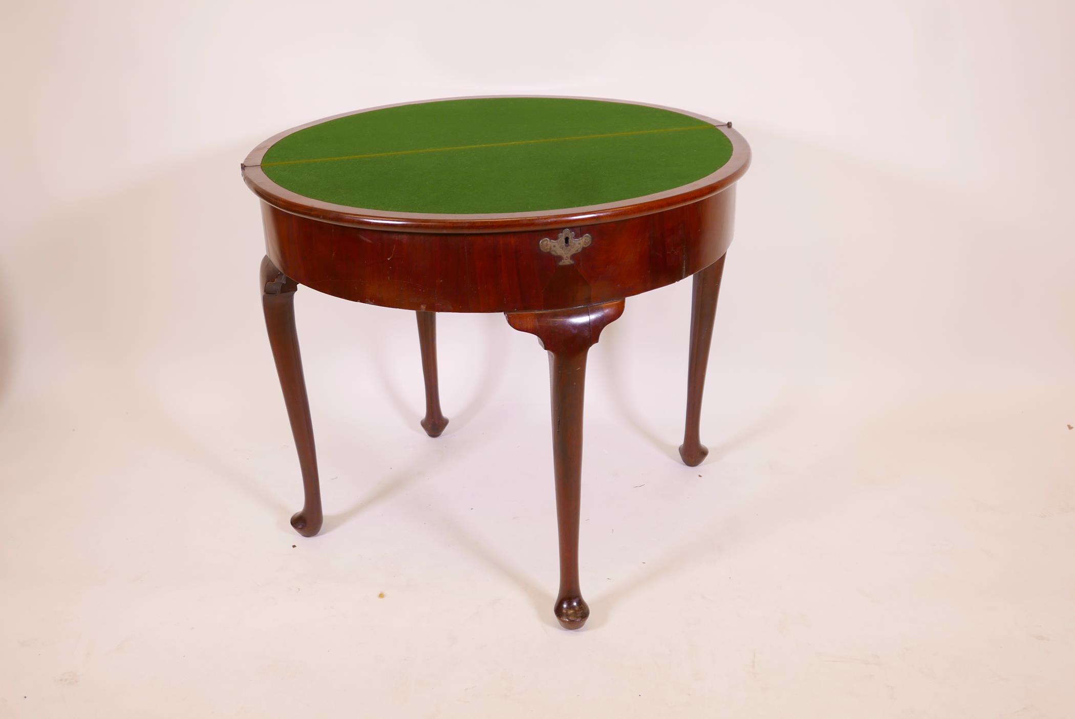 A Georgian mahogany demi lune card table, with two folding leaves opening to reveal a well, raised - Image 2 of 3