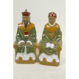 A pair of Chinese, Shiwan style, mud men figures of an emperor and empress seated on thrones, 9"