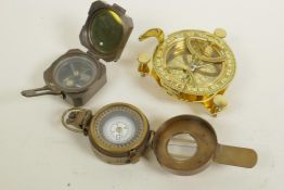 A brass tabletop sighting compass, 4" diameter, together with two brass cased pocket sighting