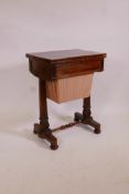 A William IV rosewood workbox, the fold over top inset with leather, the frieze drawer fitted with a