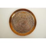 A Cairo ware copper tray chased and engraved with Islamic script, 8½" diameter