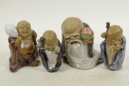 Four Chinese, Shiwan style, mud men shaven head pilgrim figures, 4½" high