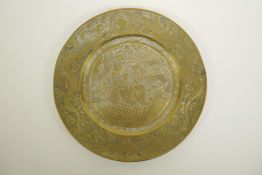 A Chinese bronze circular plaque with chased and engraved decoration of figures in a landscape to