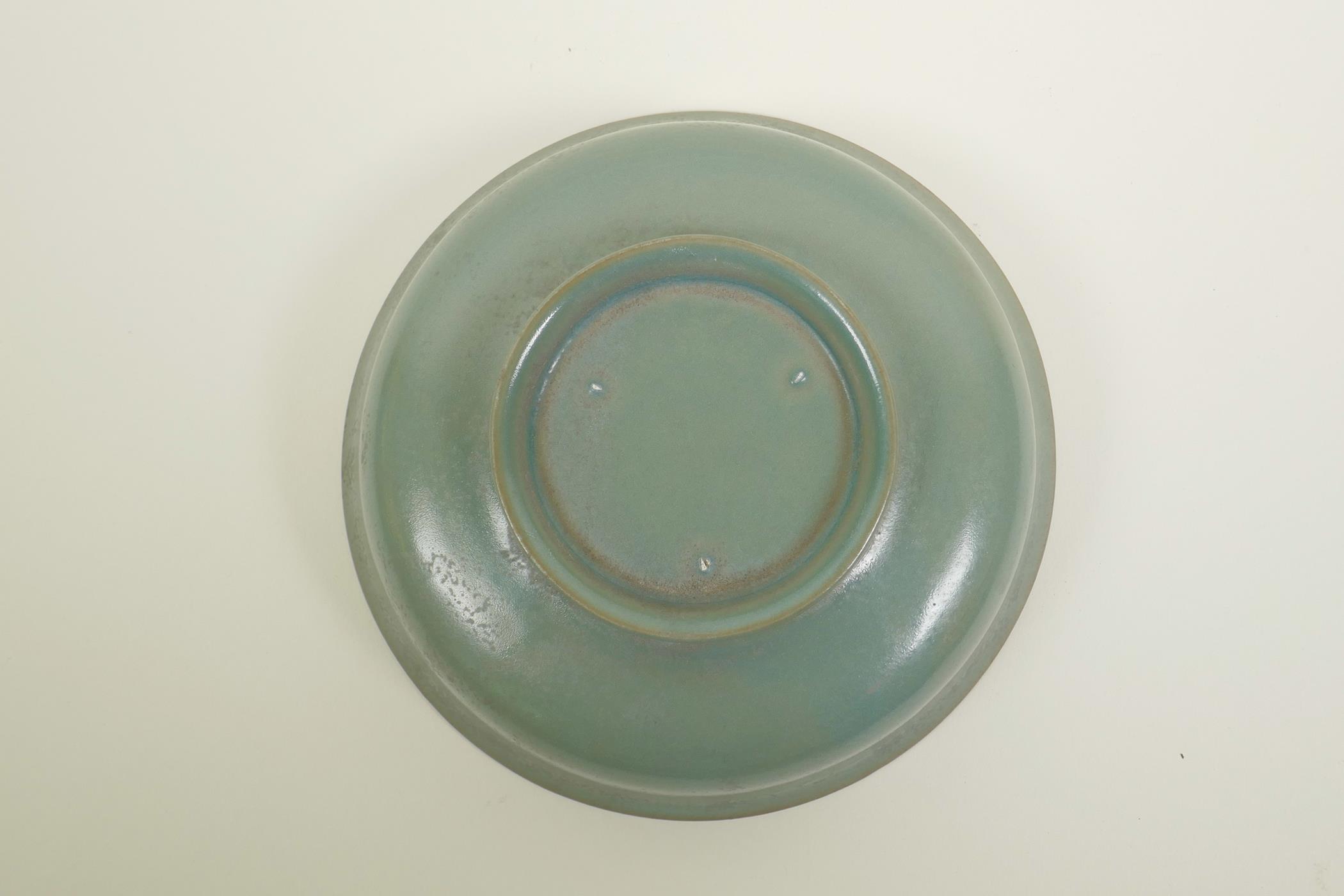 A Chinese Song style celadon glazed porcelain bowl with raised kylin and flaming pearl decoration to - Image 3 of 3