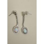 A pair of silver, cubic zirconium and opalite drop earrings, 1½" drop