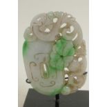 A Chinese carved jade pendant carved as a dragon and rock, 3½" high
