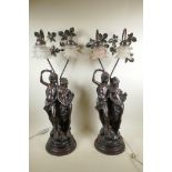 A pair of bronzed composition figural two branch lamps in the form of a courting couple, with shaped