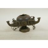 A bronze and copper hanging oil lamp with three elephant head fonts, 6½" wide