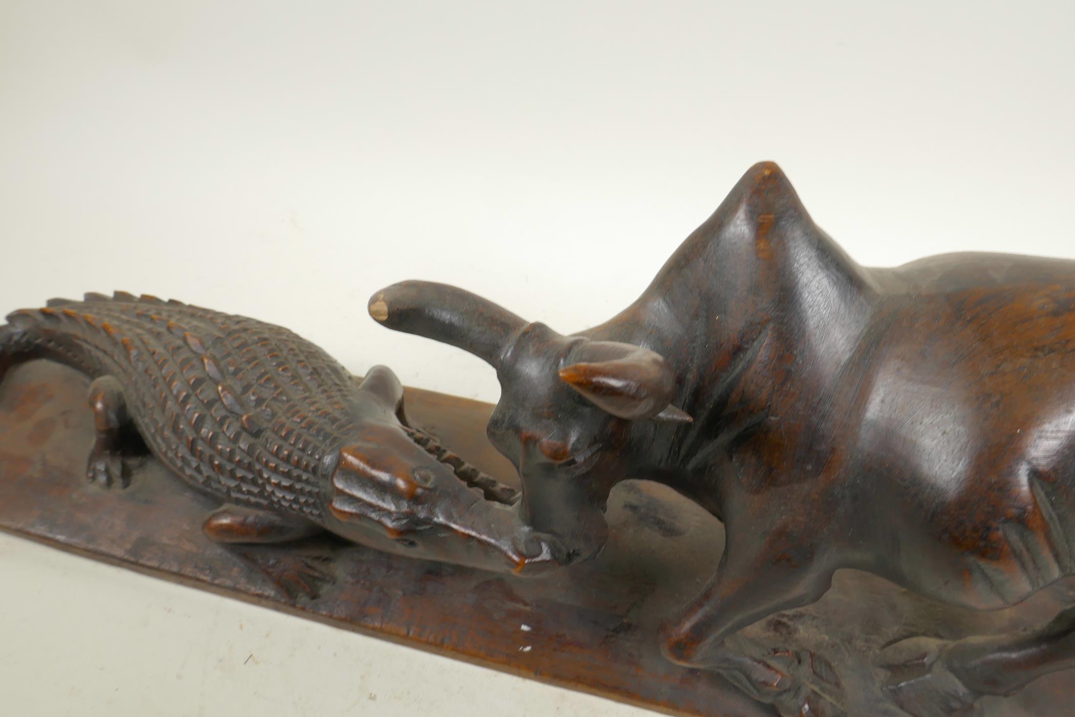 An African carved hardwood figure group decorated with a crocodile attacking a buffalo, 20½" long, - Image 2 of 6