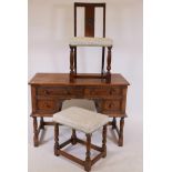 An Ipswich oak four drawer kneehole dressing/writing table, with panelled ends and carved