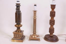 A Burmese carved wood table lamp, 19" high, and two brass table lamps
