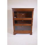 A mahogany Simpoles Chapter bookcase, three sections with glazed doors, raised on base with ogee