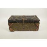 A Sino-Tibetan brass bound carved hardwood casket, with dragon and auspicious symbol decoration, and