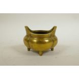 A Chinese polished brass censer with two handles, impressed seal mark to base, 4" x 4"