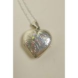 A 925 silver heart shaped locket, on a silver chain, 1½" drop
