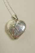 A 925 silver heart shaped locket, on a silver chain, 1½" drop