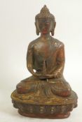 A bronze figure of Buddha seated in meditation on a lotus throne, traces of gold and red paint,