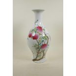 A Chinese polychrome porcelain vase decorated with a fruiting peach tree, 6 character mark to