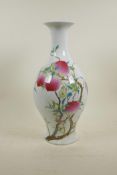 A Chinese polychrome porcelain vase decorated with a fruiting peach tree, 6 character mark to