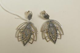 A pair of 925 silver and marcasite pendant earrings in the form of lotus flowers, 2" drop