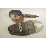 An African painted carved wood horned mask, 14" long, together with a painted carved wood bird's