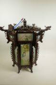 A Chinese carved hardwood octagonal hall lantern with painted glass panels, A/F, 21½" wide, 21" high