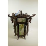 A Chinese carved hardwood octagonal hall lantern with painted glass panels, A/F, 21½" wide, 21" high