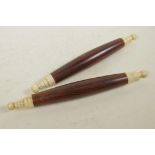 A pair of Oriental hardwood and bone scroll weights, 12" long