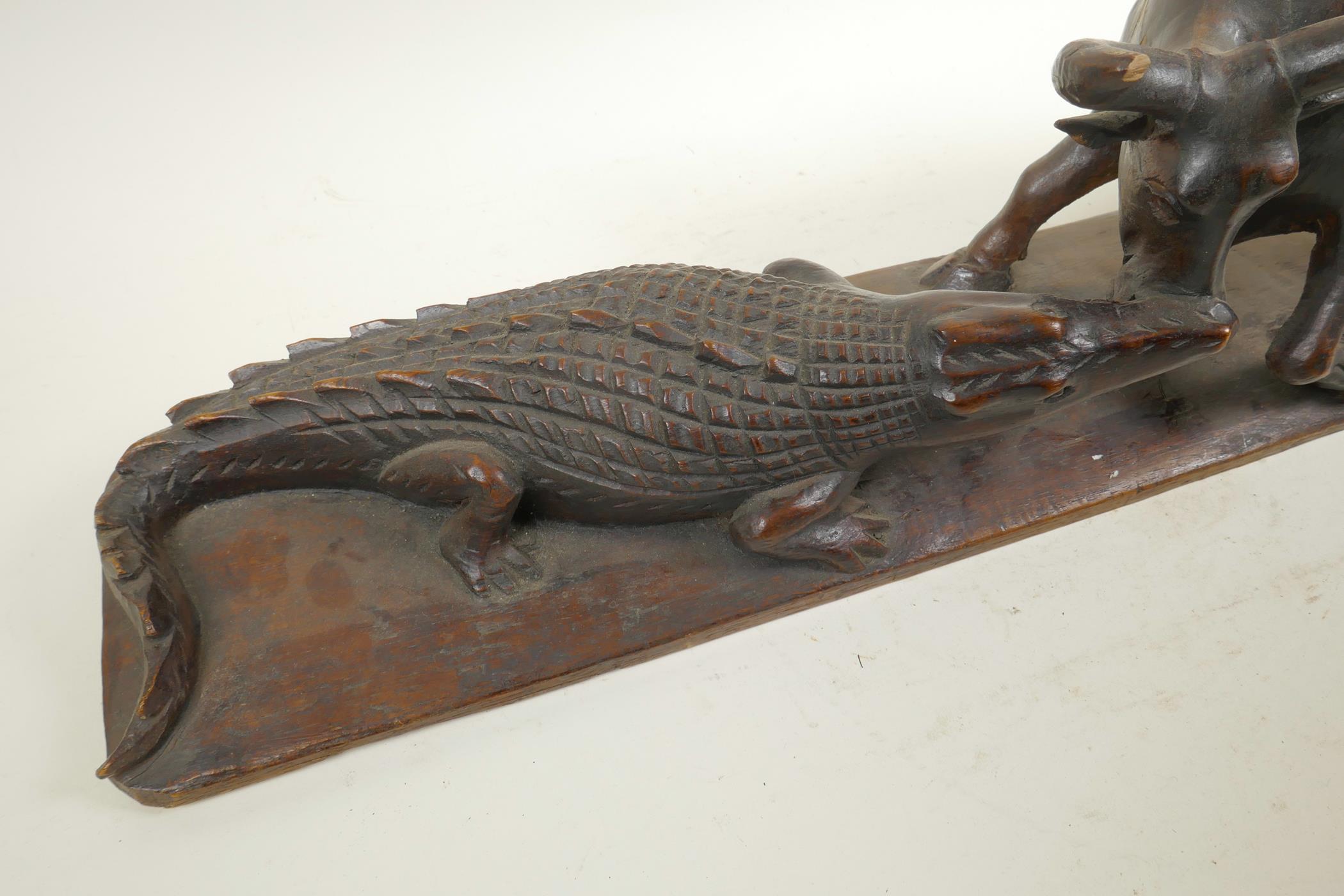 An African carved hardwood figure group decorated with a crocodile attacking a buffalo, 20½" long, - Image 3 of 6