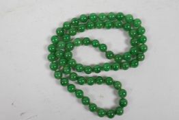 A long string of green jade beads, 32" long