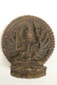 A bronze figure of a multi-armed deity, seated on a lotus throne before a large mandala, 3½" high