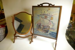 A C19th mahogany fire screen with woolwork sailing galleon panel, 28½" high, 18½" wide, together
