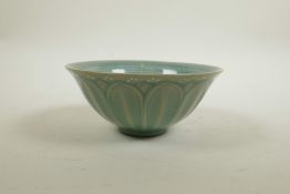 A Korean celadon glazed porcelain rice bowl with shaped lotus petal decoration, 2 character mark