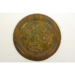 A Chinese carved hardstone ceremonial plate carved with mythical beasts, 8" diameter