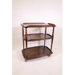 A vintage Ercol three tier dark elm serving trolley on shepherd castors, 30" high x 27" x 18"