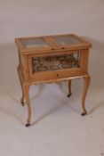 A 1920s beech rise and fall cocktail cabinet with fitted brass sections, 23" x 16", 28" high