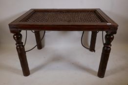 An Indian hardwood and iron table on turned supports, 30" x 45" x 30"