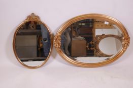 A gilt oval shaped wall mirror, 31" x 23", and another smaller