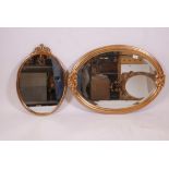 A gilt oval shaped wall mirror, 31" x 23", and another smaller