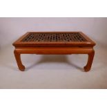 A Chinese pine coffee table with lattice carved top, 18" x 40" x 24
