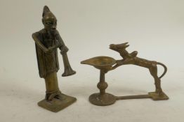 A Benin bronze figure of a musician, together with an Indian bronze oil lamp with sacred cow