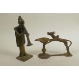 A Benin bronze figure of a musician, together with an Indian bronze oil lamp with sacred cow
