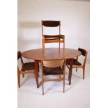 A mid C20th teak dining table with fold out leaf and matching set of four chairs, legs detachable,