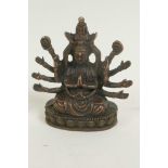 A bronze figure of a Hindu deity, seated in meditation on a lotus throne, 3" high