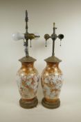 A pair of Japanese Meiji Kutani vases with brass mounts converted into lamps, decorated with Asiatic