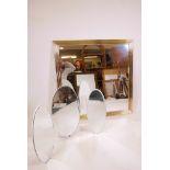 A wall mirror with reeded brass frame, 40" x 40", and a triptych dressing table mirror
